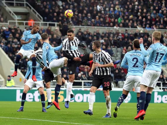 Jamaal Lascelles wins a header in Newcastle's recent win over Premier League champions Manchester City.