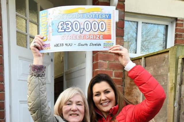 Elizabeth Adams with her cheque presented by Peoples Postcode Lottery ambassador Judie McCourt.