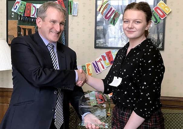 Stephanie Taylor receiving her award from Education Secretary Damien Hinds.