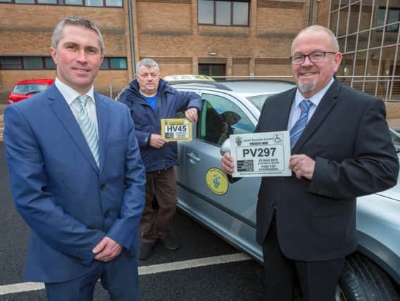 Coun Mark Walsh with Paul Pearce, chairman of the Hackney Carriage Association, and Robert Weetman, managing director of North East Accessible Transport Limited with the new style plates