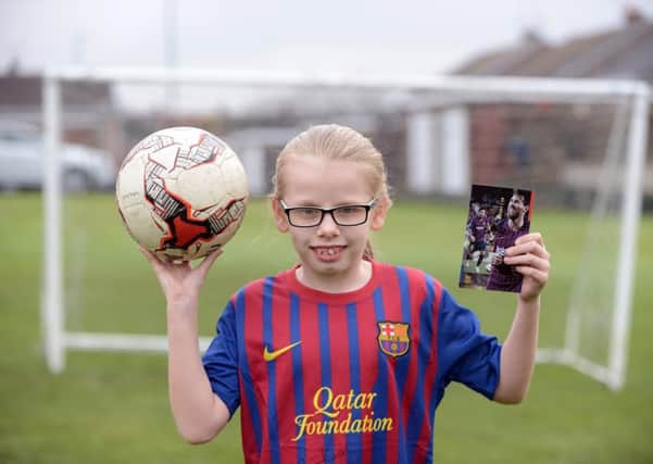 Epinay Business and Enterprise School pupil Kacie Leigh, 9 with her signed shirt and photograph from Lionel Messi