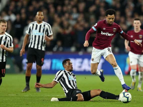 Isaac Hayden tackles Felipe Anderson.