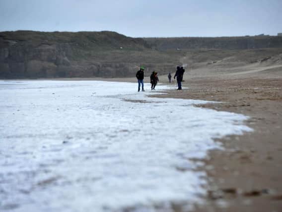 File picture: Walkers brave the cold easterly winds as they walk along Sandhaven Beach, South Shields.