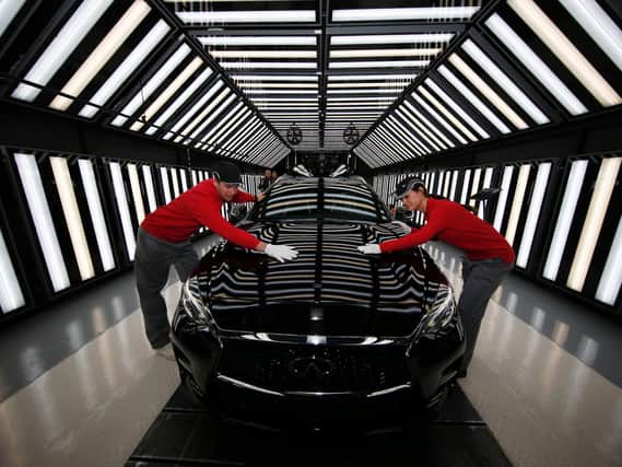Workers at Nissan's plant in Sunderland on the production line for the Infiniti Q30 vehicle.