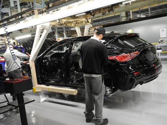 Workers build an Infiniti car on the line at Sunderland when the Q30 model was first launched in 2015.