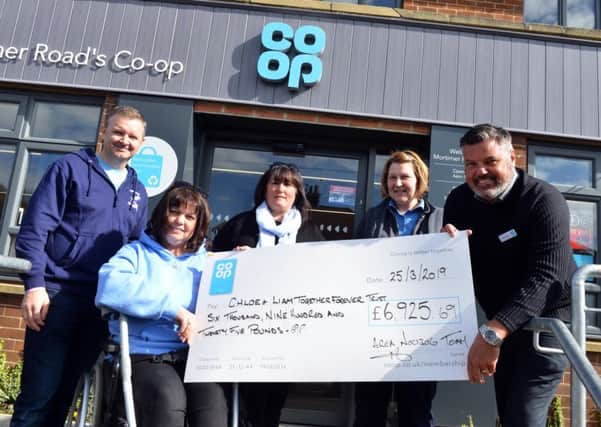 Chloe and Liam Together Forever Trust recive funds from the Co-op.
From left family's  Mark and Lisa Rutherford with Caroline Curry, store team manager Julie Gardner and area manager Michael Boucher