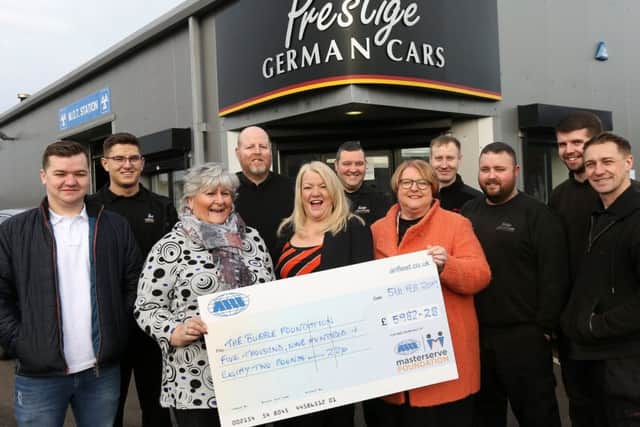 Front, from left, Jan Lord, of the Masterserve Foundation, , Lorraine Morgan, Gill Wheeldon and staff from Prestige German Cars with a cheque for the Bubble Foundation