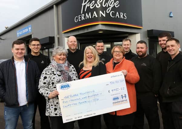 Front, from left,  Jan Lord, of the Masterserve Foundation, , Lorraine Morgan, Gill Wheeldon and staff from Prestige German Cars with a cheque for the Bubble Foundation