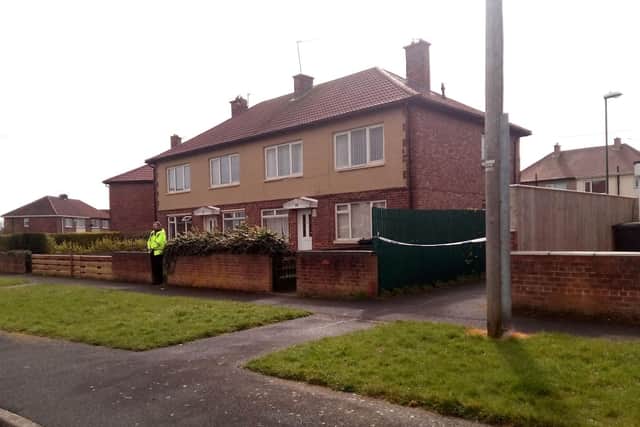 A police officer stands on guard at the house in Jarrow where a man was found dead early today.