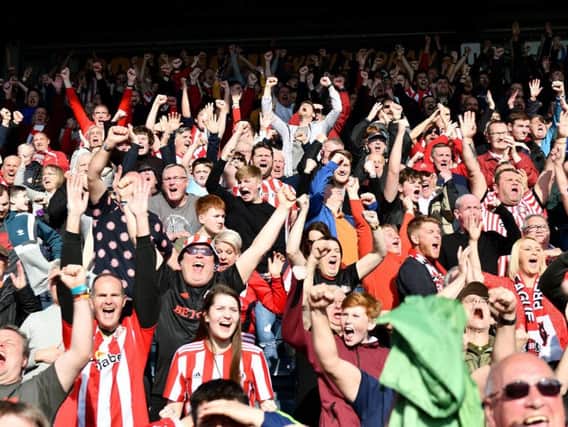 Sunderland supporters celebrate the victory.