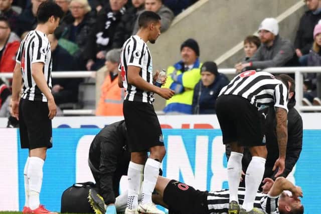 Florian Lejeune is treated after suffering a knee injury.