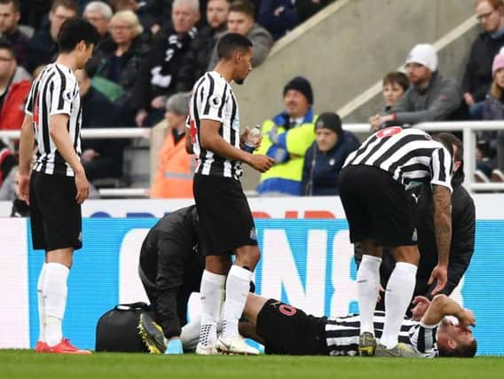 Florian Lejeune is treated after suffering a knee injury.