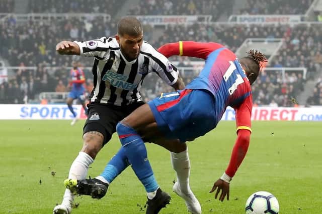 DeAndre Yedlin challenges Wilfried Zaha.