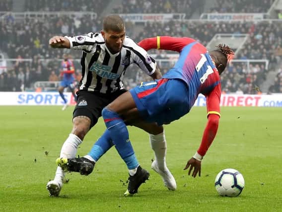 DeAndre Yedlin challenges Wilfried Zaha.