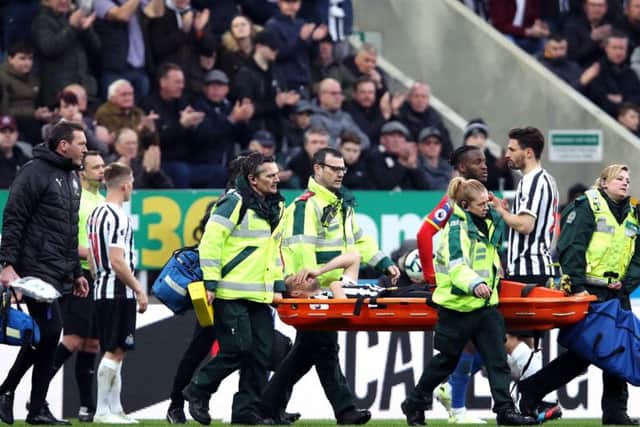 Florian Lejeune is stretchered off the pitch.