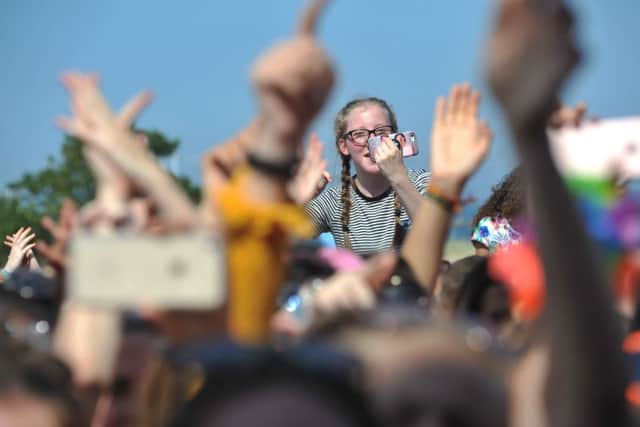 Waving at the camera.