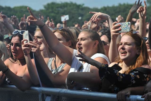 At the front of the crowd.