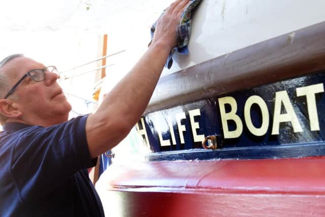 Jerry gives the boat a final polish.