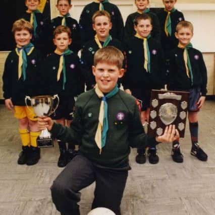 Team captain Callum Rochford and the other winning players of the Seventh Cub Scout football team in 1996.