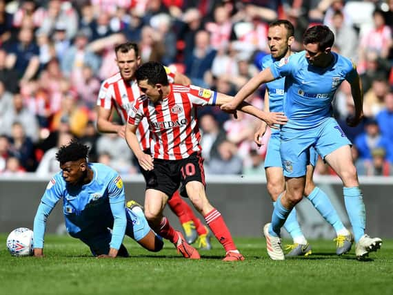 George Honeyman battles for the ball.
