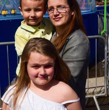Jan Slater with children Jasmine (8) and Jacob (5) after a soaking on the Log Flume ride.