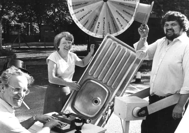 Wood Terrace Field Day in 1983. Bill Dodds on typwriter, Theresa Moor with kitchen sink and George Stanners on slimming machine.