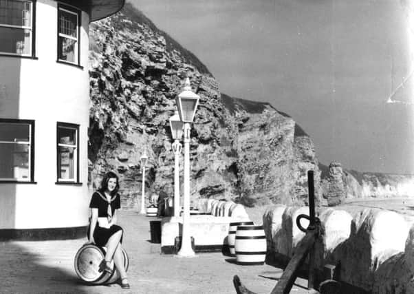 Waitress Ann Price looks over Marsden Bay from the Grotto terrace in 1972.