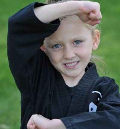Six-year-old Grace Townsley demonstrates her karate  moves.
