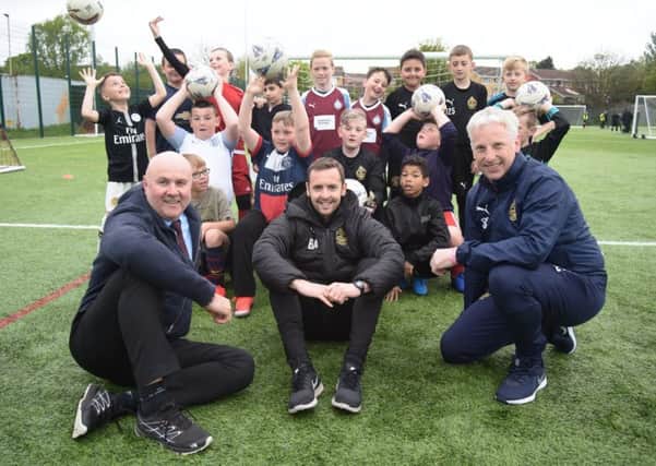 Port of Tyne head of operations Graeme Hardie (left0 with South Shields FC player and Foundation coach Blair Adams and SSFC Foundation Head Steve Camm and children at the club's Let's Play Thursday session.