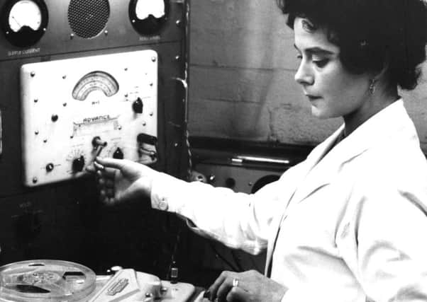 Supervisor Terri Dutton puts a tape machine through its paces at the Ferrograph factory.