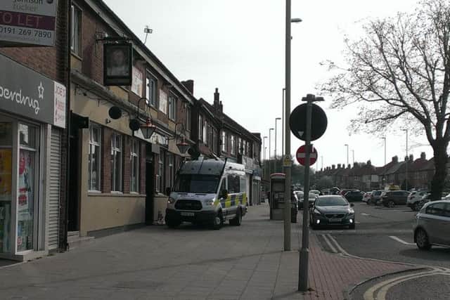 Police outside the pub in the aftermath of Ronnie Howard's death, with a huge amount of flowers later left as the community paid its respects to the father-of-two.