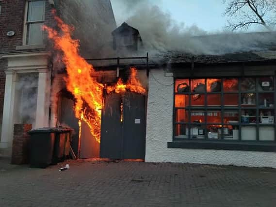 Fire tears through the garage building. Picture by Ian David Kirby.