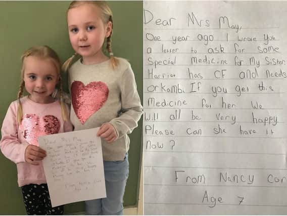 Harriet Corr and sister Nancy and the letter Nancy has written to PM Theresa May.