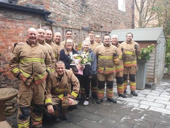 Firefighters present Sharon Gallagher and daughter Beth with flowers