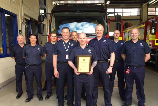 Firefighter Sargent receives his award from Chief Fire Officer Chris Lowther (third right)