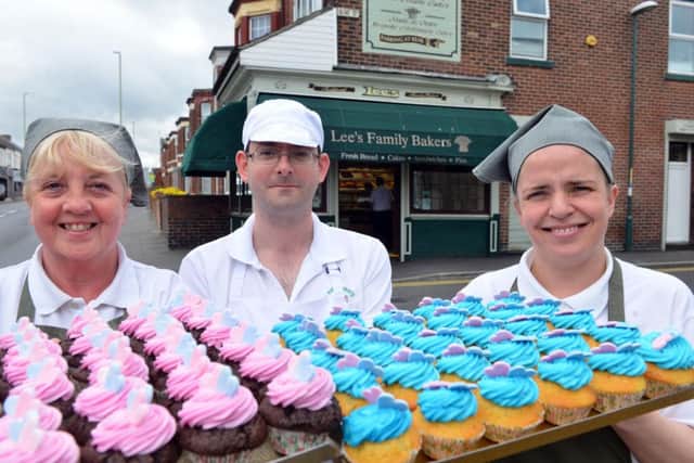 Lee's Bakery is selling pink and blue cakes to mark the anniversary. (From left) Carole Cook, Andrew Gregg and Tara Lee.