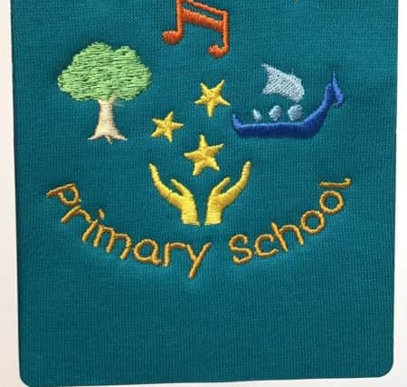 How the new badge will look on the school's sweater.
