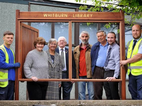 From left window: Coun Tracey Dixon, Nancy Maxwell and Peter Boyack, with Friends of Whitburn Library members Rory Thomson, Kevin Fail and Richard Day, and South Tyneside Homes staff, with the newly installed community notice board at Whitburn Library.