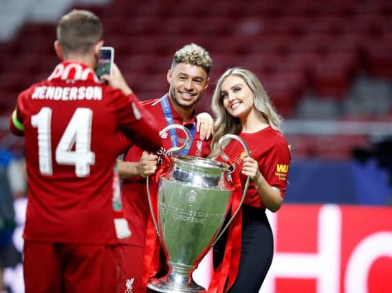 Little Mix star Perrie Edwards and boyfriend Alex Oxlade-Chamberlain pose for a picture taken by Liverpool captain Jordan Henderson after the Reds' Champions League win over Tottenham Hotspur.