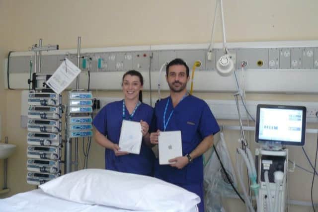 Staff Nurse Danielle Harrison and Consultant Intensivist Dr Riccardo Scano with tablet computers donated to the Intensive Therapy Unit at South Tyneside District Hospital by Jason Heseltons family in his memory