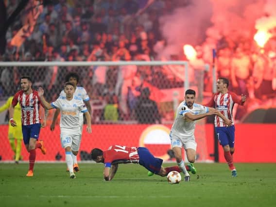 Gabi of Atletico Madrid is tackled by Morgan Sanson of Marseille during the UEFA Europa League Final between Olympique de Marseille and Club Atletico de Madrid at Stade de Lyon on May 16, 2018  (Photo by Matthias Hangst/Getty Images).