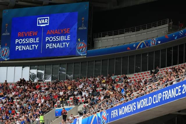 NICE, FRANCE - JUNE 09: The giant screen shows a VAR message as a penalty is reviewed during the 2019 FIFA Women's World Cup France group D match between England and Scotland at Stade de Nice on June 9, 2019 in Nice, France. (Photo by Marc Atkins/Getty Images)