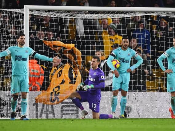 Fabian Schar, Martin Dubravka, Jamaal Lascelles and Florian Lejeune of Newcastle United react as Willy Boly of Wolverhampton Wanderers scores his team's first and qualizing goal during the Premier League match between Wolverhampton Wanderers and Newcastle United at Molineux on February 11, 2019 in Wolverhampton, United Kingdom. (Photo by Stu Forster/Getty Images)