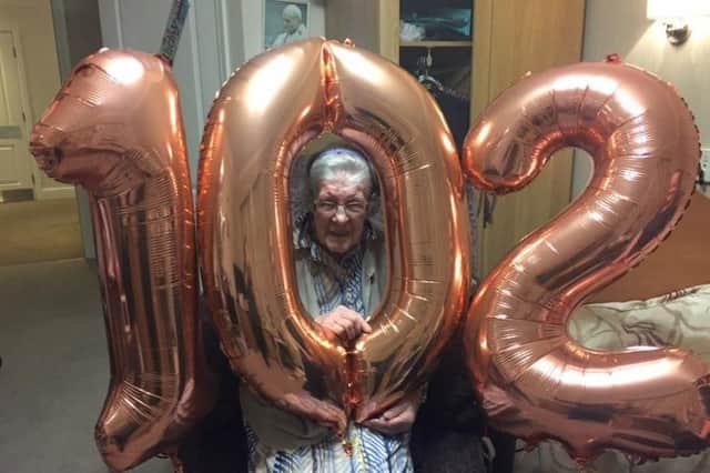 Polly celebrates with her 102 birthday balloon
