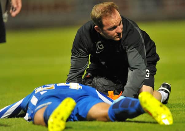 INJURED: Charlie Wyke on the ground injured against Northampton Town. Picture by FRANK REID