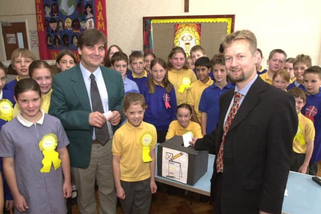 Pictured at St Wilfreds RC School, Millhouses Lane, Sheffield, where children held a mini general election as part of their school citizens project. Seen is MP Richard Allen as he casts his vote watched by pupils and Coun Roger Davison school govenor.