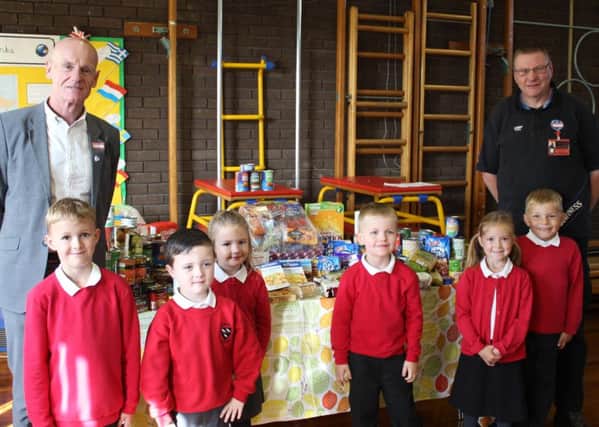 East Durham Trust's Malcolm Fallow, left, with Year 2 pupils from Cotsford Infant School and foodbank volunteer Kenneth Lincoln.
