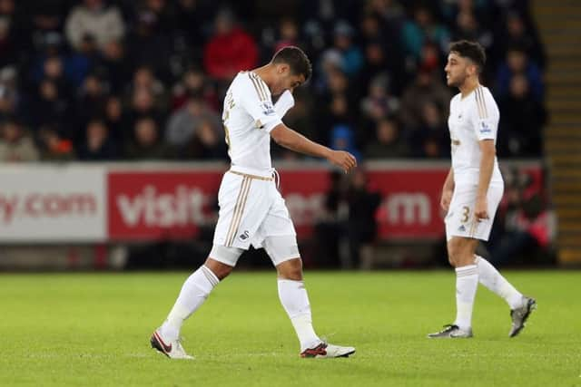 Kyle Naughton trudges off after his red card