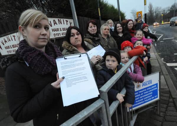 Petition organiser Michelle Walters is joined by fellow Lord Blyton Primary School parents and children at the Wenlock Road crossing.