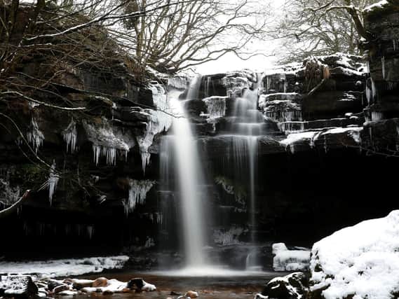 A waterfall surrounded by icicles at Gibsons cave in Bowlees Visitor Centre, County Durham.